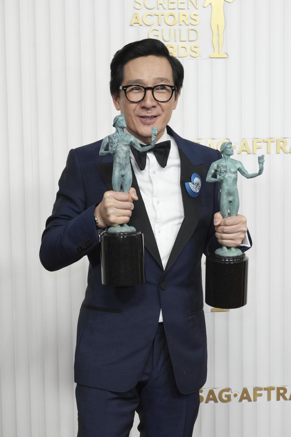 Ke Huy Quan, winner of the award for outstanding performance by a male actor in a supporting role and outstanding performance by a cast in a motion picture for "Everything Everywhere All at Once," poses in the press room at the 29th annual Screen Actors Guild Awards on Sunday, Feb. 26, 2023, at the Fairmont Century Plaza in Los Angeles. (Photo by Jordan Strauss/Invision/AP)