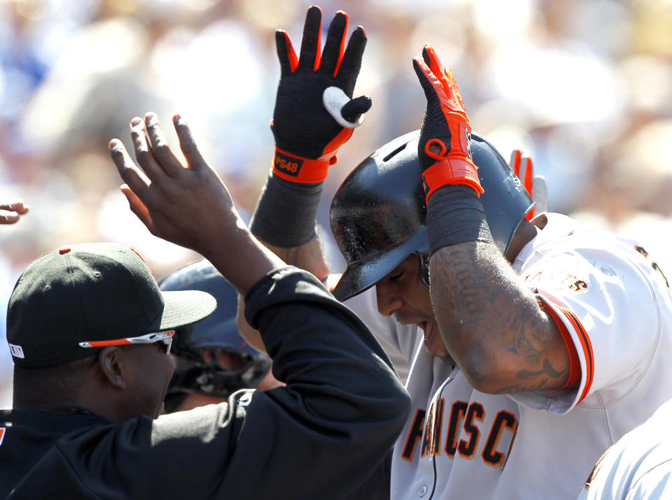 San Francisco Giants' Pablo Sandoval, right, shouts as he celebrates with teammates after hitting three-run home run against the Los Angeles Dodgers in the fifth inning of a baseball game on Saturday, April 5, 2014, in Los Angeles. (AP Photo/Alex Gallardo)