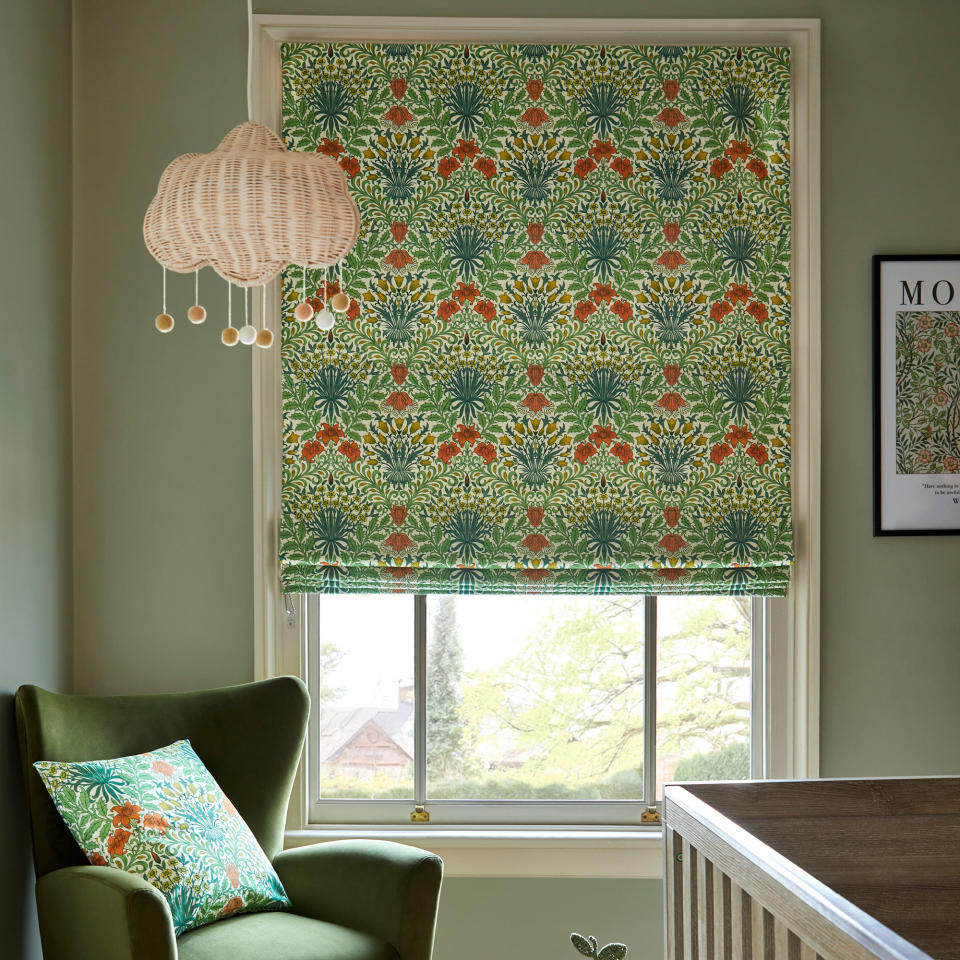 Green William Morris patterned blind in green nursery with green chair