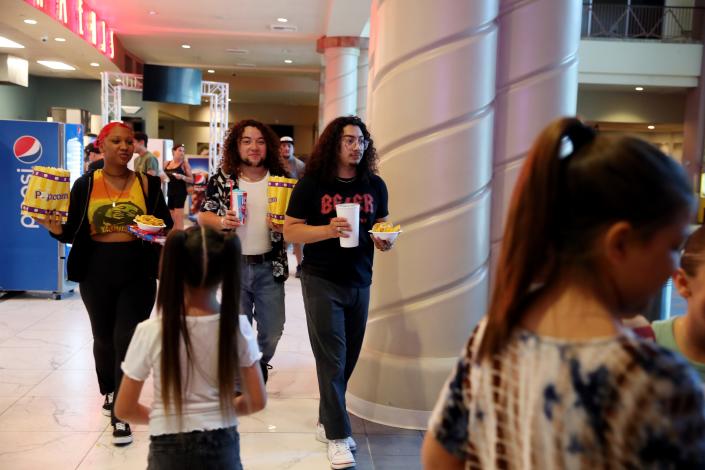 Moviegoers Leann Mullen, left, Oliver Boquin and Moses Boquin prepare to see &quot;Minions: The Rise of Gru&quot; at Mary Pickford is D’Place in Cathedral City, Calif., on June 30, 2022.