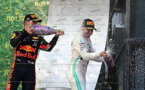 Mercedes' Finnish driver Valtteri Bottas (R) and third-placed Red Bull Racing's Dutch driver Max Verstappen celebrate on the podium after the Formula One Australian Grand Prix in Melbourne on March 17, 2019 - Credit: AFP