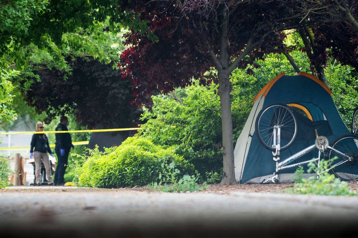 Davis Police investigate on Tuesday, May 2, 2023, the site where a homeless woman was stabbed several times through the side of her tent near Second and L streets before midnight. The city issued issued a shelter in place order that was lifted around 5 a.m.
