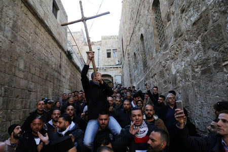 Worshippers shout slogans during a protest near the closed entrance to the Church of the Holy Sepulchre in Jerusalem's Old City, February 27, 2018. REUTERS/Ammar Awad