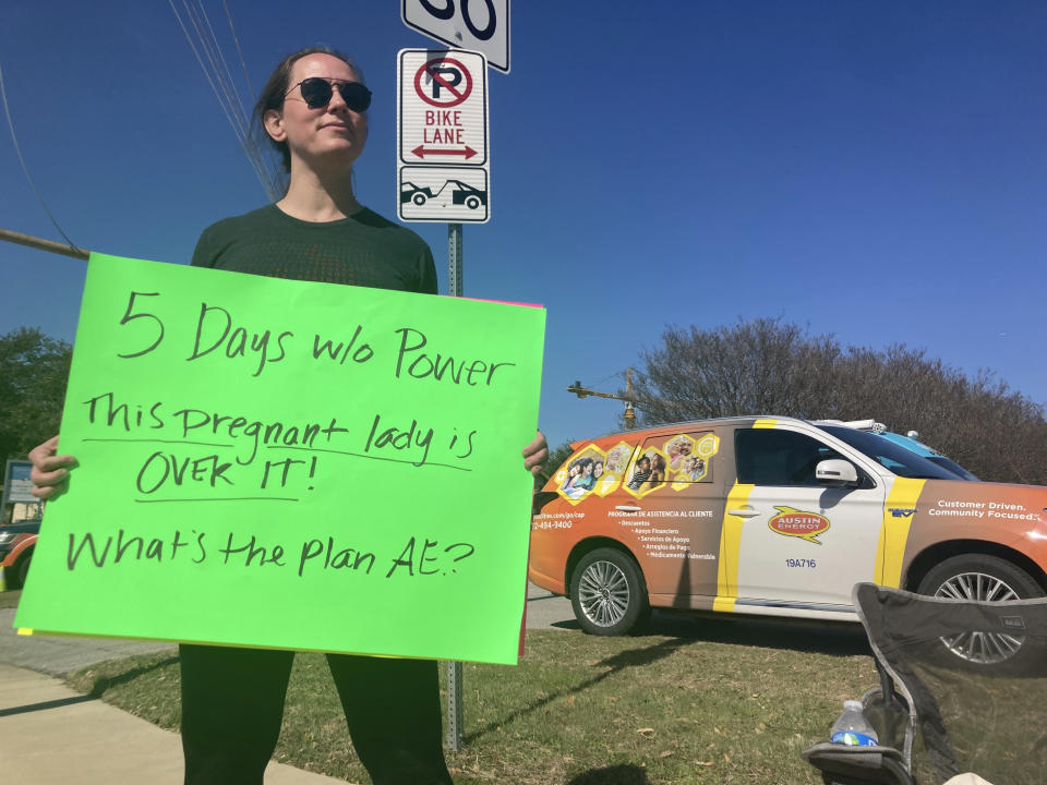 CORRECTS SPELLING OF LAST NAME TO MANGANELLA INSTEAD OF MAGANELLA - Katy Manganella, 37, protests in front of an Austin Energy truck in her neighborhood in Austin, Texas, Sunday, Feb. 5, 2023. Thousands of Austin residents remained without power days after an ice storm knocked out electricity to nearly a third of the city's customers. (AP Photo/Paul Weber)