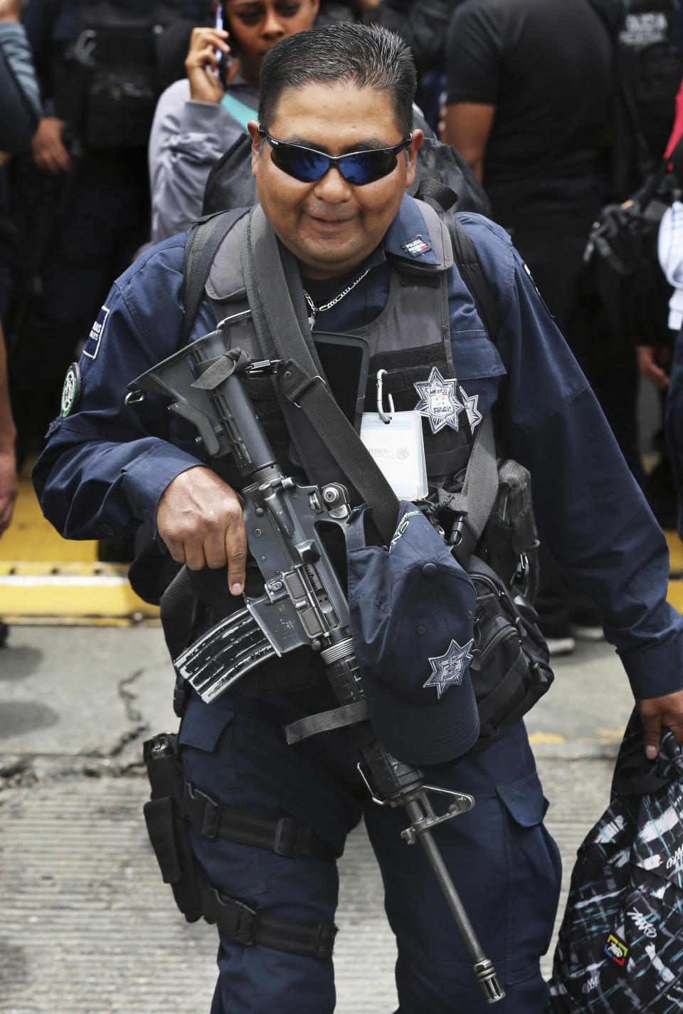 A uniformed Mexican federal police arrives to a police command center in the Iztapalapa borough of Mexico City, Wednesday, July 3, 2019, to protest plans to force federal police into the newly formed National Guard. Hundreds of Mexican federal police are in open revolt Wednesday against plans to absorb them into the newly formed National Guard, saying their seniority, rank and benefits are not being recognized within the National Guard. (AP Photo/Marco Ugarte)