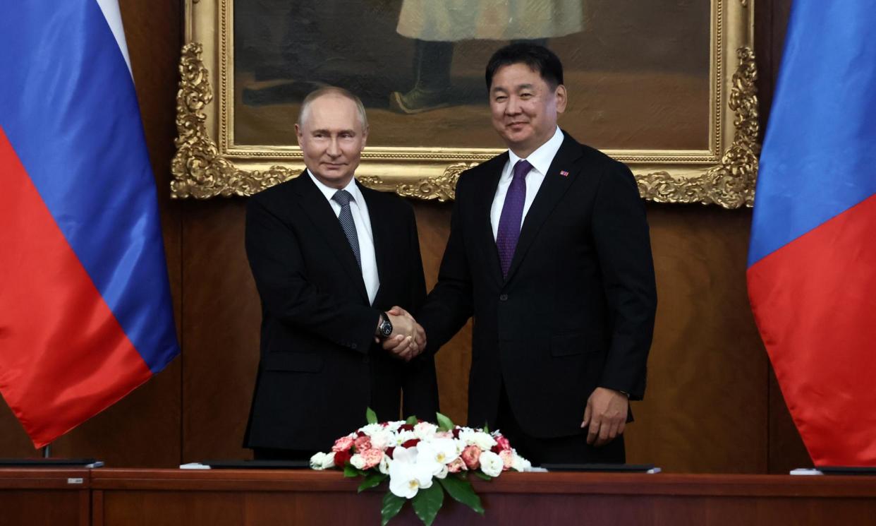 <span>Vladimir Putin shakes hands with President Ukhnaagiin Khürelsükh on Tuesday during the Russian leader’s trip to Ulaanbaatar.</span><span>Photograph: Sofia Sandurskaya/Sputnik/Kremlin pool/EPA</span>