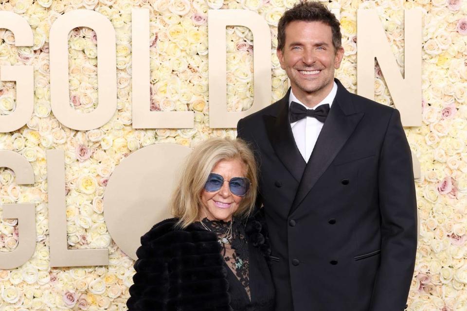 <p>Kevin Mazur/Getty </p> Bradley Cooper and his mom at the 2024 Golden Globes