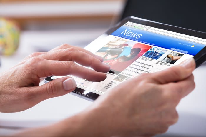 Woman reading news on a tablet