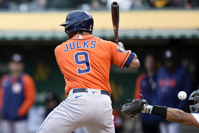 Oakland Athletics catcher Carlos Pérez, right, is unable to catch James Kaprielian's pitch to Houston Astros' Corey Julks, left, during the third inning of a baseball game in Oakland, Calif., Friday, May 26, 2023. Astros' Yordan Alvarez scored on the play. (AP Photo/Godofredo A. Vásquez)