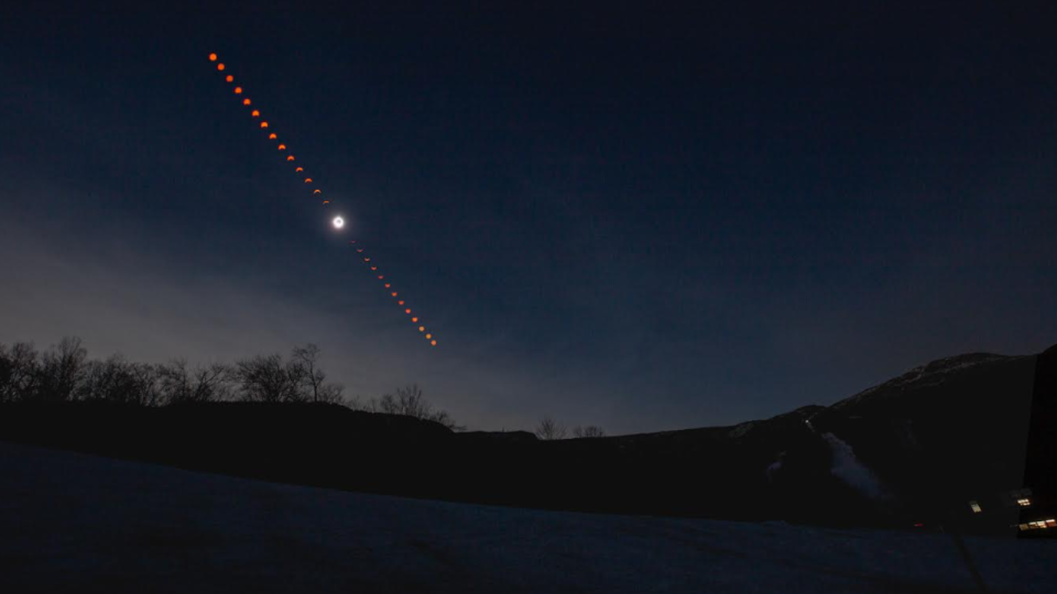 A sequence of images show the eclipse through different phases as the sun travels through the sky with a mountain silhouetted in the foreground.