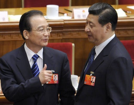 Chinese Premier Wen Jiabao (left) talks to Vice President Xi Jinping after a meeting at the Great Hall of the People in Beiijing on March 11 . Xi has made his first public appearance in two weeks, state media said, following swirling speculation about the whereabouts of Beijing's leader-in-waiting