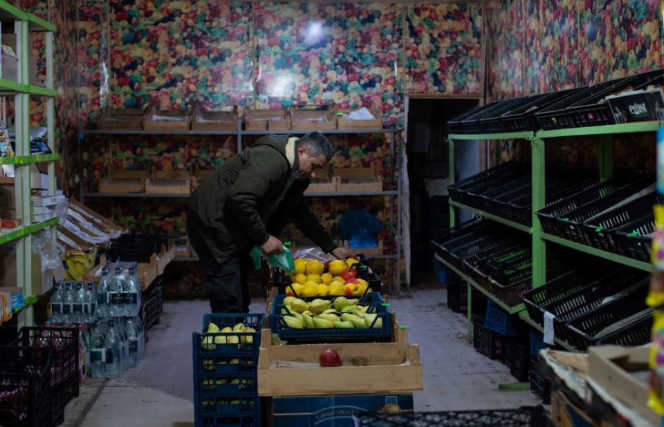 A man holds fruit in an empty market in Stepanakert, the capital of Nagorno-Karabakh, on December 23, 2022.<span class="copyright">Davit Ghahramanyan—AFP/Getty Images</span>