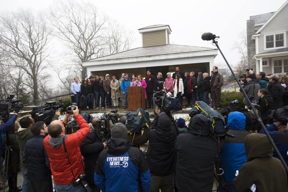 Members of the media watch as family members of the victims killed in the Sandy Hook Elementary School tragedy give a statement just before the one year anniversary of the disaster in Sandy Hook