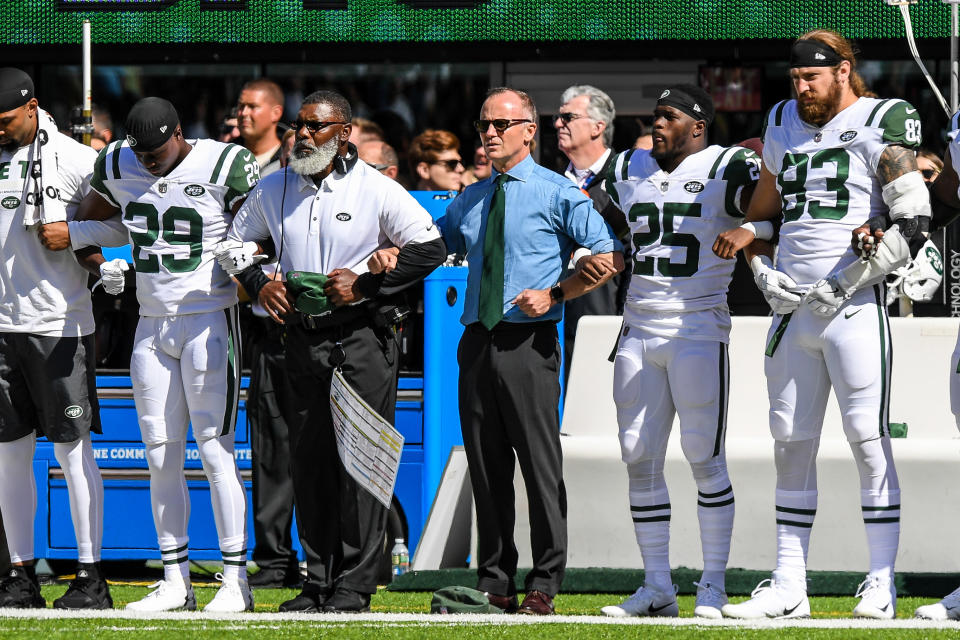 <p>New York Jets acting CEO Christopher Johnson locks arms with the entire New York Jets team during the playing of the national anthem before the game between New York Jets and the Jacksonville Jaguars at MetLife Stadium. Mandatory Credit: Dennis Schneidler-USA TODAY Sports </p>