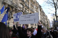 A woman holds up a sign which reads "Long live a free Ukraine" during a demonstration in front of the Russian embassy in Paris, France, Tuesday, Feb. 22, 2022. World leaders are getting over the shock of Russian President Vladimir Putin ordering his forces into separatist regions of Ukraine and they are focusing on producing as forceful a reaction as possible. Germany made the first big move Tuesday and took steps to halt the process of certifying the Nord Stream 2 gas pipeline from Russia. (AP Photo/Francois Mori)