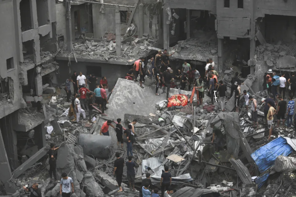 Palestinians inspect the damage of destroyed buildings following Israeli airstrikes on Gaza City, Friday, Oct. 27, 2023. (AP Photo/Abed Khaled)