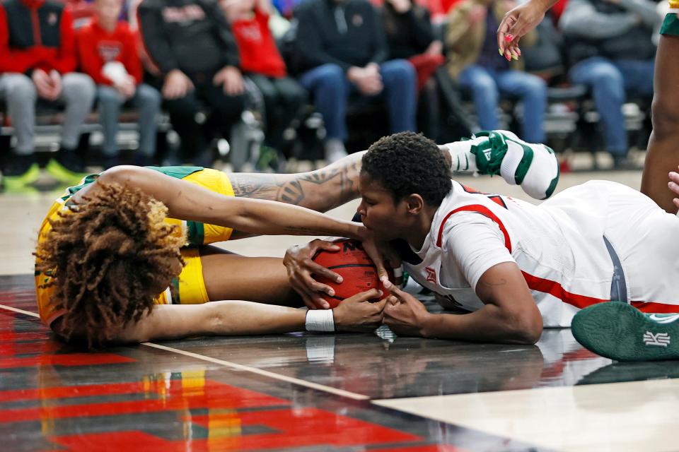 Baylor's NaLyssa Smith (1) and Texas Tech's Khadija Faye (23) dive on the court for the ball during the first half of an NCAA college basketball game on Wednesday, Jan. 26, 2022, in Lubbock, Texas. (AP Photo/Brad Tollefson) ORG XMIT: TXBT109