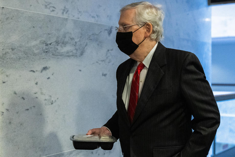 Senate Majority Leader Sen. Mitch McConnell of Ky., holds his boxed lunch as he leaves a Senate Republican policy meeting on Capitol Hill, Thursday, Sept. 17, 2020, in Washington. (AP Photo/Manuel Balce Ceneta)