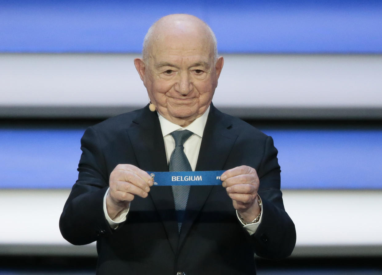 Former Russian soccer player Nikita Simonyan holds up the team name of Belgium the 2018 soccer World Cup draw. (AP)