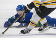 Vancouver Canucks right wing Vasily Podkolzin (92) looks for the puck against the Boston Bruins during the second period of an NHL hockey game Wednesday, Dec. 8, 2021 in Vancouver, British, Columbia. (Jonathan Hayward/The Canadian Press via AP)