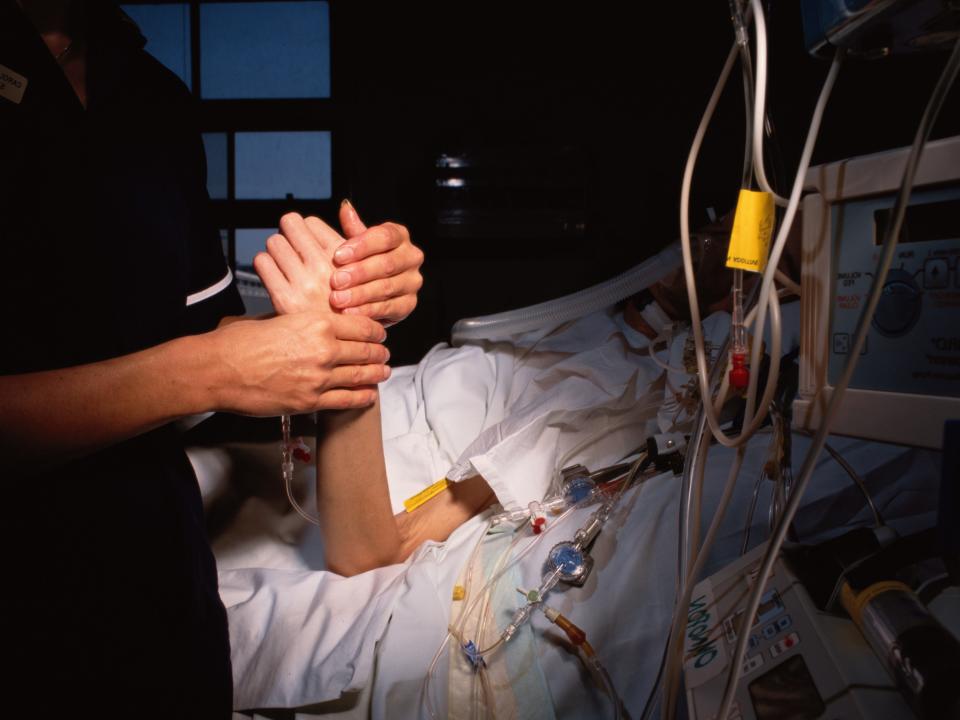 Nurse Checks Patient's Pulse - stock photo