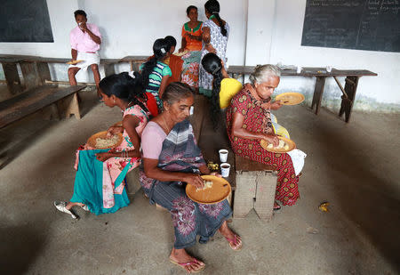 People eat in a relief camp after they were evacuated from their homes, after flooding caused by Cyclone Ockhi in the coastal village of Chellanam in the southern state of Kerala, India, December 2, 2017. REUTERS/Sivaram V