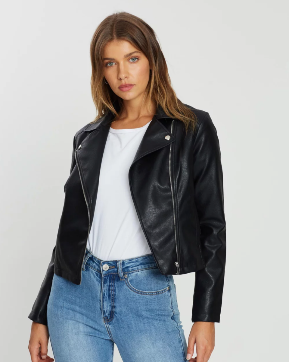 Model wearing black faux-leather jacket and jeans, from The Iconic