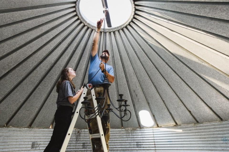 jared cappie capp and alex hang a chandelier in the grain bin bbq, as seen on building outside the lines, season 1