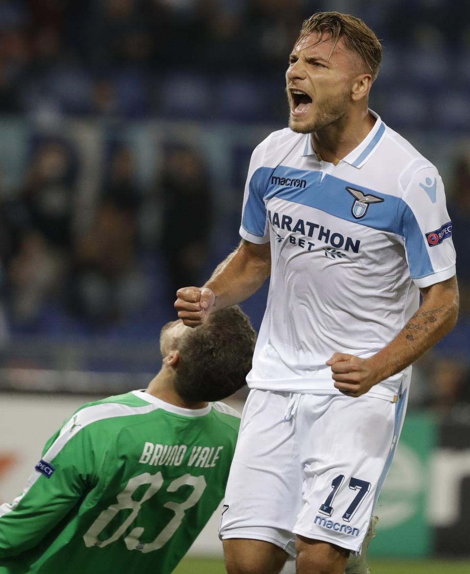 Lazio's Ciro Immobile celebrates after scoring on a penalty during an Europa League, group H, soccer match between Lazio and Apollon Limassol, in Rome, Thursday, Sept. 20, 2018. Apollon goalkeeper Bruno Vale reacts in dejection in the background. (AP Photo/Andrew Medichini)