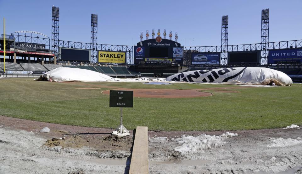 This Monday, March 17, 2014 photo taken in Chicago, shows U.S. Cellular Field, home to the Chicago White Sox baseball team, as groundskeepers work to ready the field for opening day after one of the most brutal winters the city has ever seen. (AP Photo/M. Spencer Green)