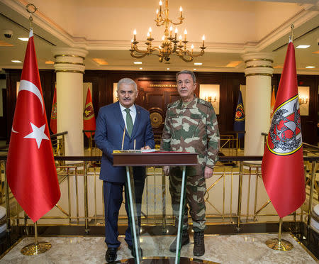 FILE PHOTO: Turkish Prime Minister Binali Yildirim meets with Chief of the General Staff Hulusi Akar at the armed forces' headquarters in Ankara, Turkey January 20, 2018. Ali Balikci/Prime Minister's Press Office/Handout via REUTERS