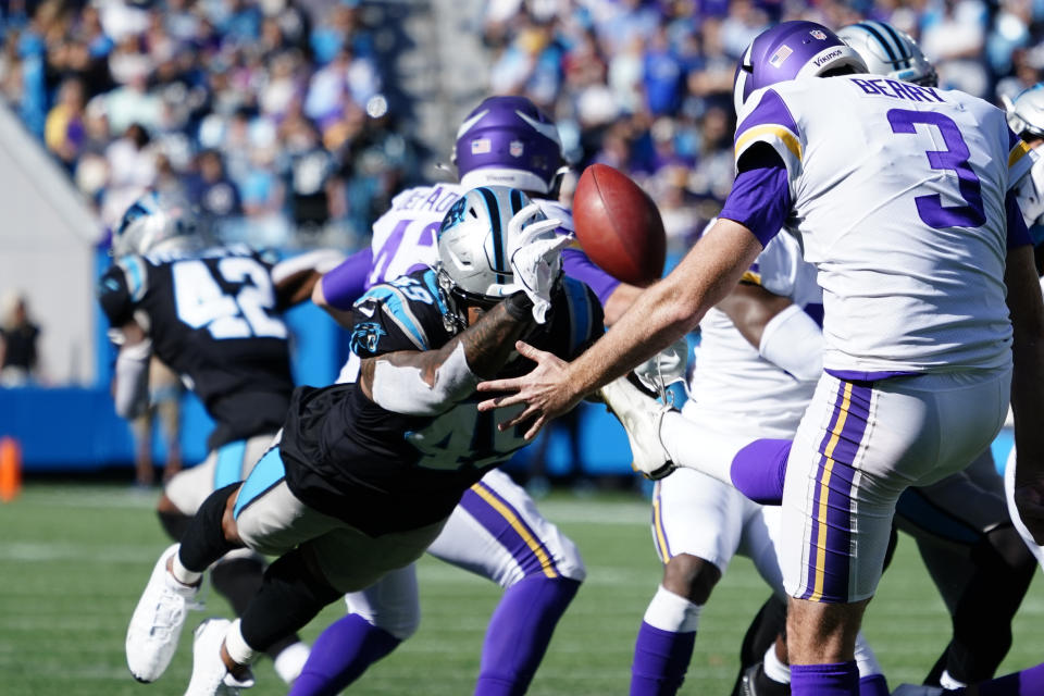 Carolina Panthers linebacker Frankie Luvu (49) blocks the punt of Minnesota Vikings punter Jordan Berry (3) during the second half of an NFL football game, Sunday, Oct. 17, 2021, in Charlotte, N.C. Carolina Panthers safety Kenny Robinson picked up the ball for a touchdown. (AP Photo/Jacob Kupferman)