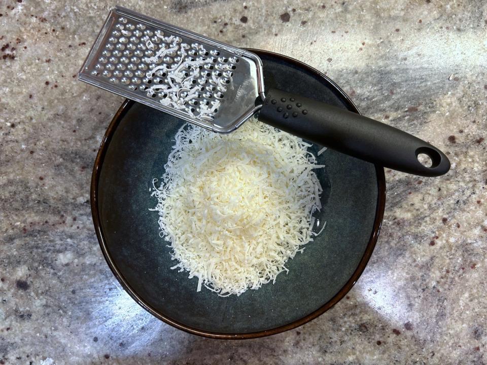 Grating cheese for Ina Garten's ravioli en brodo