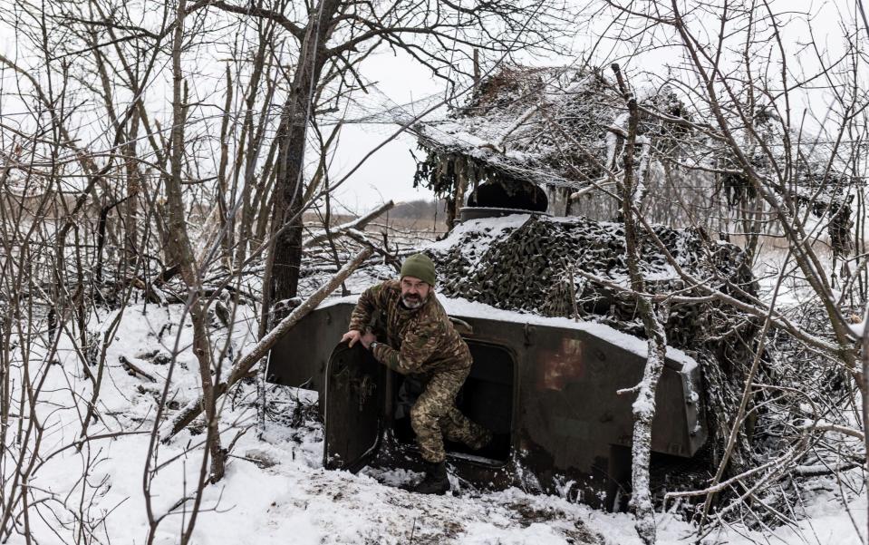 A Ukrainian soldier exits an artillery vehicle in Kharkiv Oblast