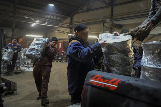 Volunteers load heating stoves into a truck to deliver them for Ukrainians, in a workshop in Siauliai, some 230 km (144 miles) north-west of the capital Vilnius, Lithuania, Thursday, Feb. 2, 2023. Since Russia invaded Ukraine last February, Lithuania, Latvia and Estonia — three states on NATO’s eastern flank scarred by decades of Soviet-era occupation — have been among the top donors to Kyiv. (AP Photo/Sergei Grits)