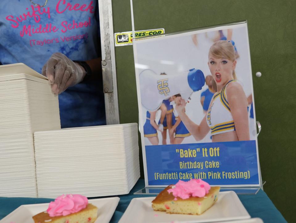 Erlene Preston sets up plates of "Bake It Off" birthday cake at a celebration for Taylor Swift's birthday at Swift Creek Middle School on Tuesday, Dec. 13, 2022.