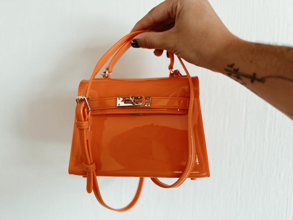 orange purse with gold buckle