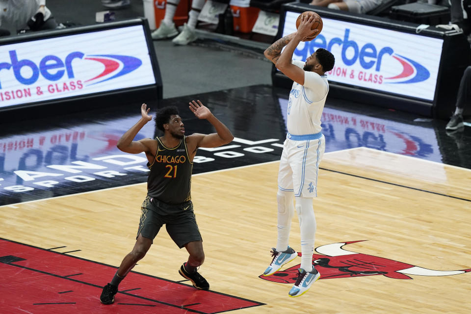 Los Angeles Lakers forward Anthony Davis, right, shoots against Chicago Bulls forward Thaddeus Young during the first half of an NBA basketball game in Chicago, Saturday, Jan. 23, 2021. (AP Photo/Nam Y. Huh)