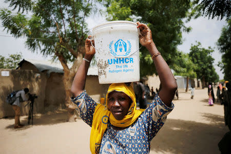 A woman carries a bucket of water at the Banki IDP camp, in Borno, Nigeria April 26, 2017. Picture taken April 26, 2017. REUTERS/Afolabi Sotunde