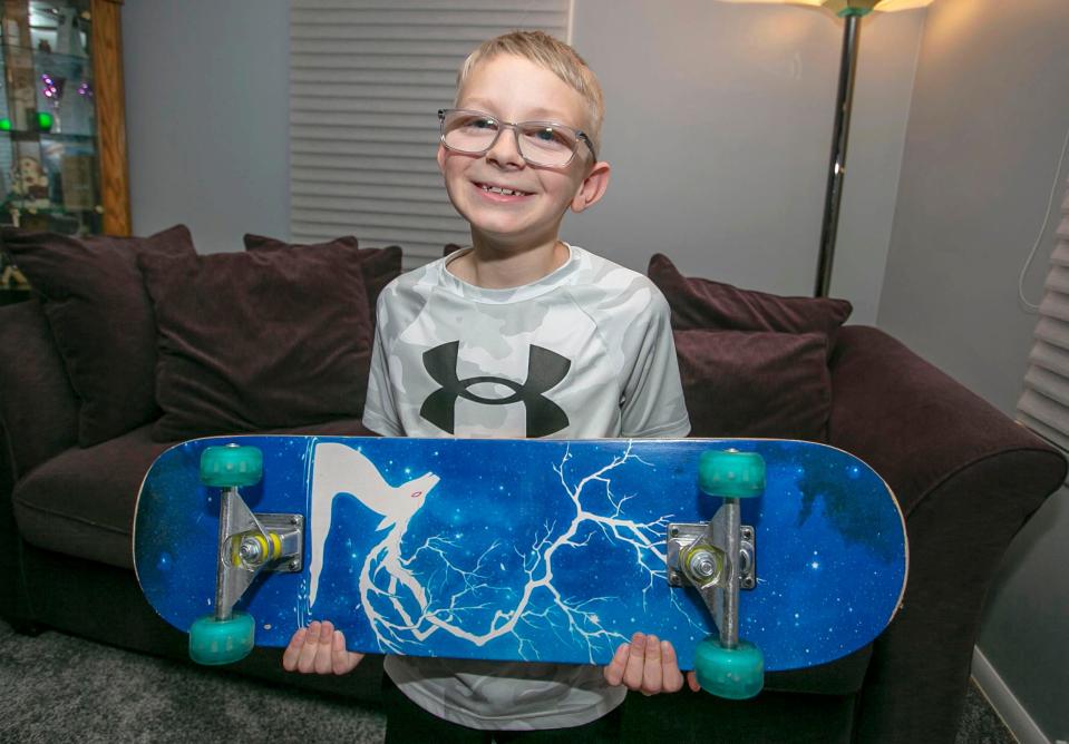 Liam Kautzer, 10, of Sheboygan, poses with a skateboard, Jan. 11, 2022, in Sheboygan. Liam, a fifth grader at Pigeon River Elementary School, spent the summer selling Beados so he could buy skateboards for other children.