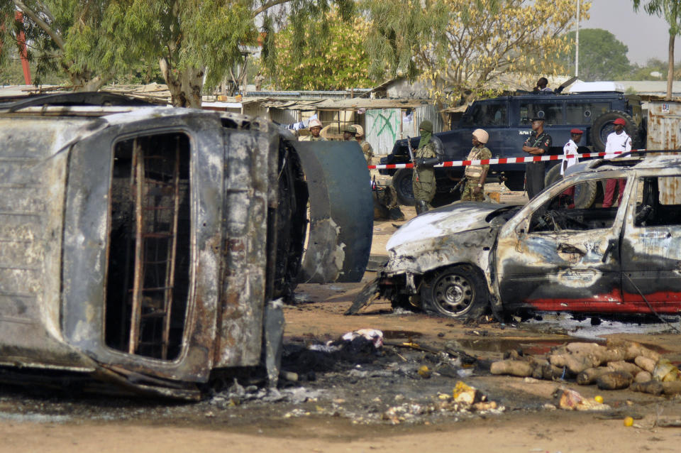 FILE - In this Feb. 24, 2015 file photo, police officers stand guard following a suicide bomb explosion at a bus station in Kano, Nigeria. Radical Islamic militants from Boko Haram are increasingly forcing children to carry out bombings, with the number of attacks since January already nearly reaching the total for all of last year, according to a report released Wednesday, April 12, 2017 by the U.N. children’s agency. (AP Photo/Sani Maikatanga, File)