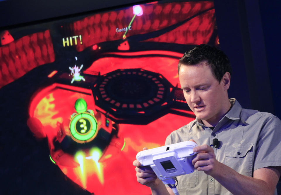 Nintendo's Bill Trinen demonstrates the Wii U GamePad, Thursday, Sept. 13, 2012 in New York. The gaming console will start at $300 and go on sale in the U.S. on Nov. 18, in time for the holidays, the company said Thursday. (AP Photo/Mark Lennihan)