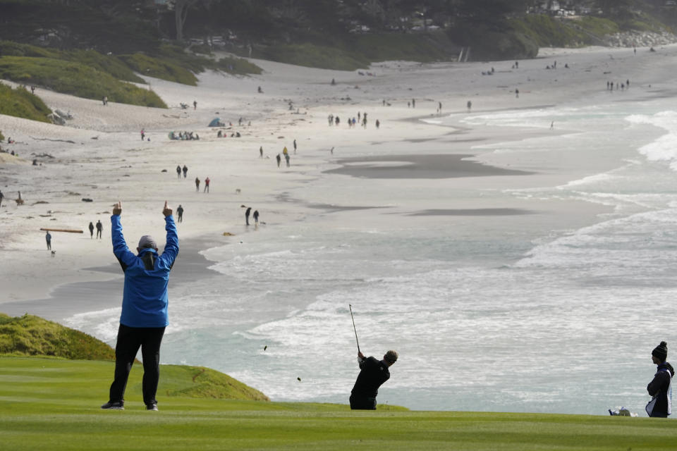 Luke Donald, center, hits from the ninth fairway of the Pebble Beach Golf Links during the second round of the AT&T Pebble Beach Pro-Am golf tournament Friday, Feb. 12, 2021, in Pebble Beach, Calif. (AP Photo/Eric Risberg)