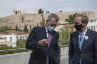 U.S. Ambassador to Greece Geoffrey Pyatt, left, speaks with Microsoft President Brad Smith, during a ceremony held in the Acropolis Museum, in the background the ancient Parthenon temple, in central Athens, on Monday, Oct. 5, 2020. Microsoft has announced plans to build three data centers in greater Athens, providing a badly needed investment of up to $1 billion to the Greek economy which has been hammered by the pandemic. (AP Photo/Petros Giannakouris)