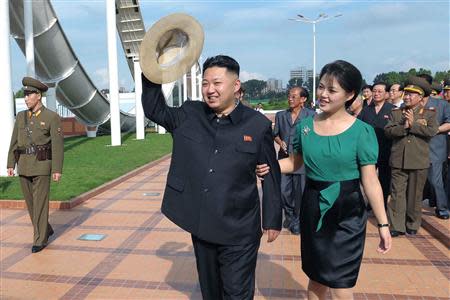 North Korean leader Kim Jong-Un and his wife Ri Sol-Ju attend the opening ceremony of the Rungna People's Pleasure Ground on Rungna Islet along the Taedong River in Pyongyang in this July 25, 2012 file photograph released by the North's KCNA to Reuters on July 26, 2012. REUTERS/KCNA/Files