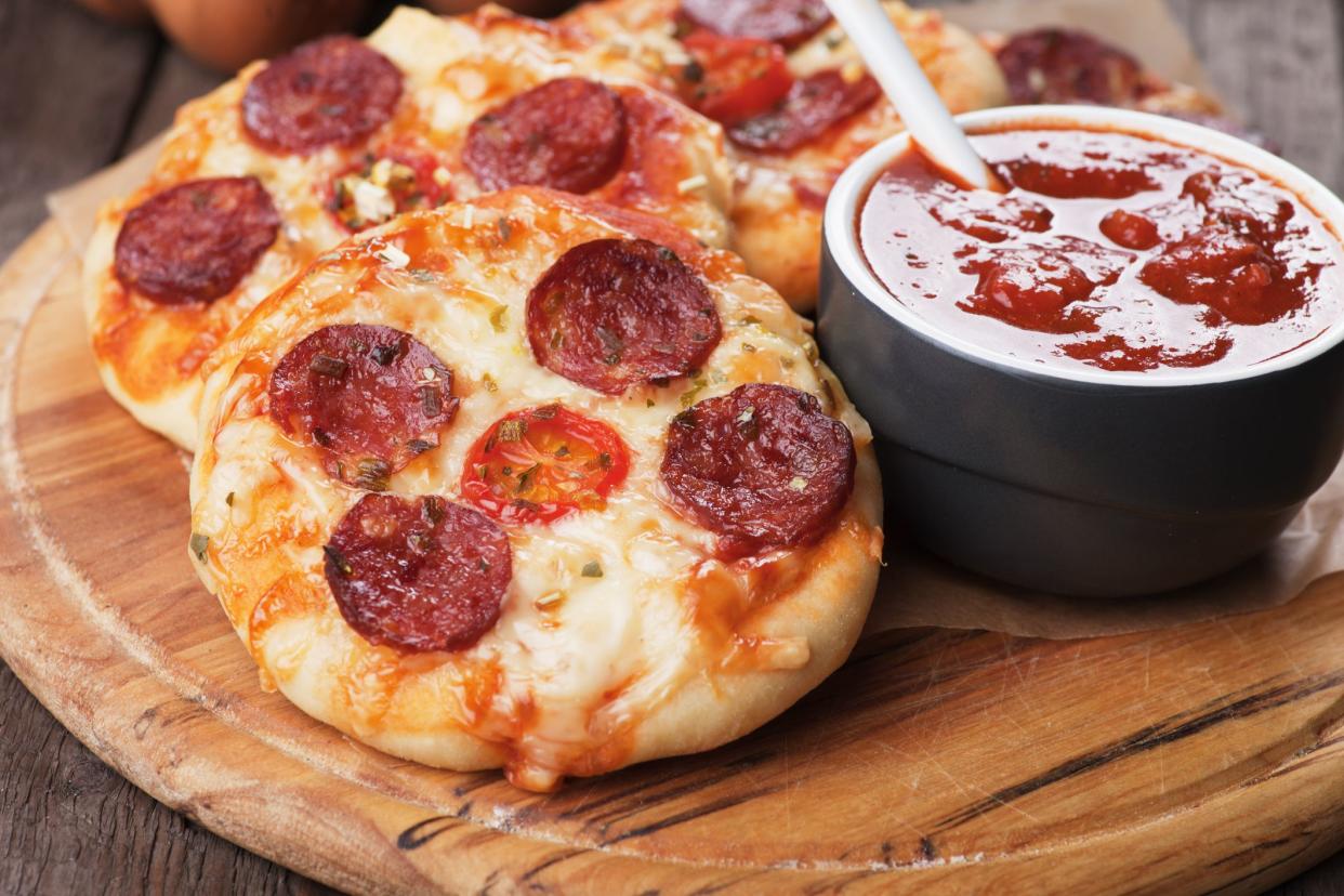 Mini pizzas with salami, cheese and tomato