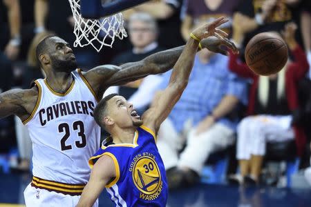 Cleveland Cavaliers forward LeBron James (23) blocks the shot by Golden State Warriors guard Stephen Curry (30) during the fourth quarter in game six of the NBA Finals at Quicken Loans Arena. Mandatory Credit: Ken Blaze-USA TODAY Sports