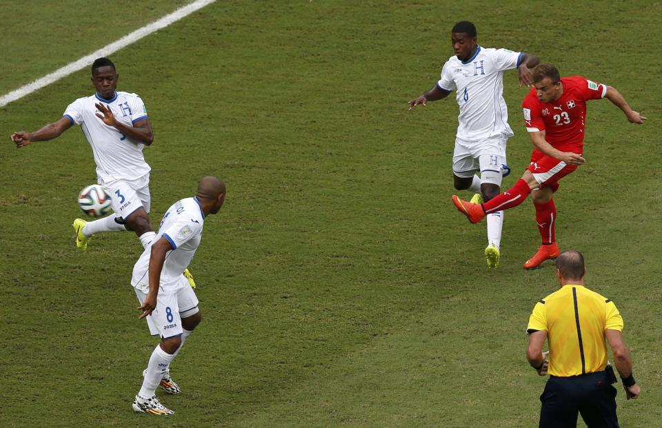 Switzerland's Xherdan Shaqiri (23) scores a goal during their 2014 World Cup Group E soccer match against Honduras at the Amazonia arena in Manaus June 25, 2014. REUTERS/Andres Stapff (BRAZIL - Tags: SOCCER SPORT WORLD CUP TPX IMAGES OF THE DAY)