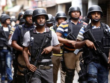 Security personnel leave the site after a police operation on militants on the outskirts of Dhaka, Bangladesh, July 26, 2016. REUTERS/Mohammad Ponir Hossain