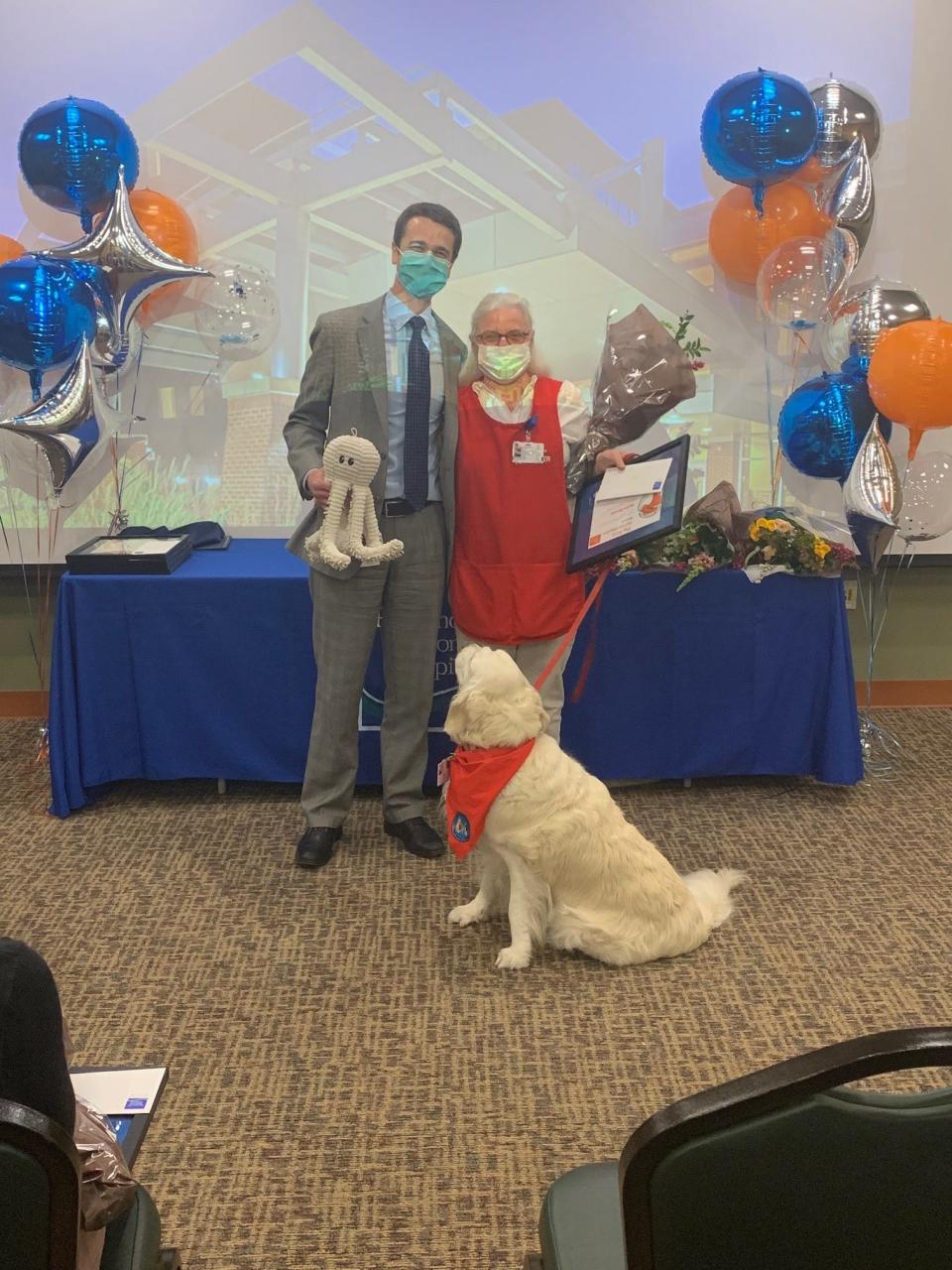 Jackie Dewey of Cape Neddick, Maine, received the 2021 Frist Humanitarian Award – Volunteer. Her English Cream Golden Retriever, Lacey, is always by her side, including as she accepted the award from Dean M. Carucci, CEO of Portsmouth Regional Hospital.